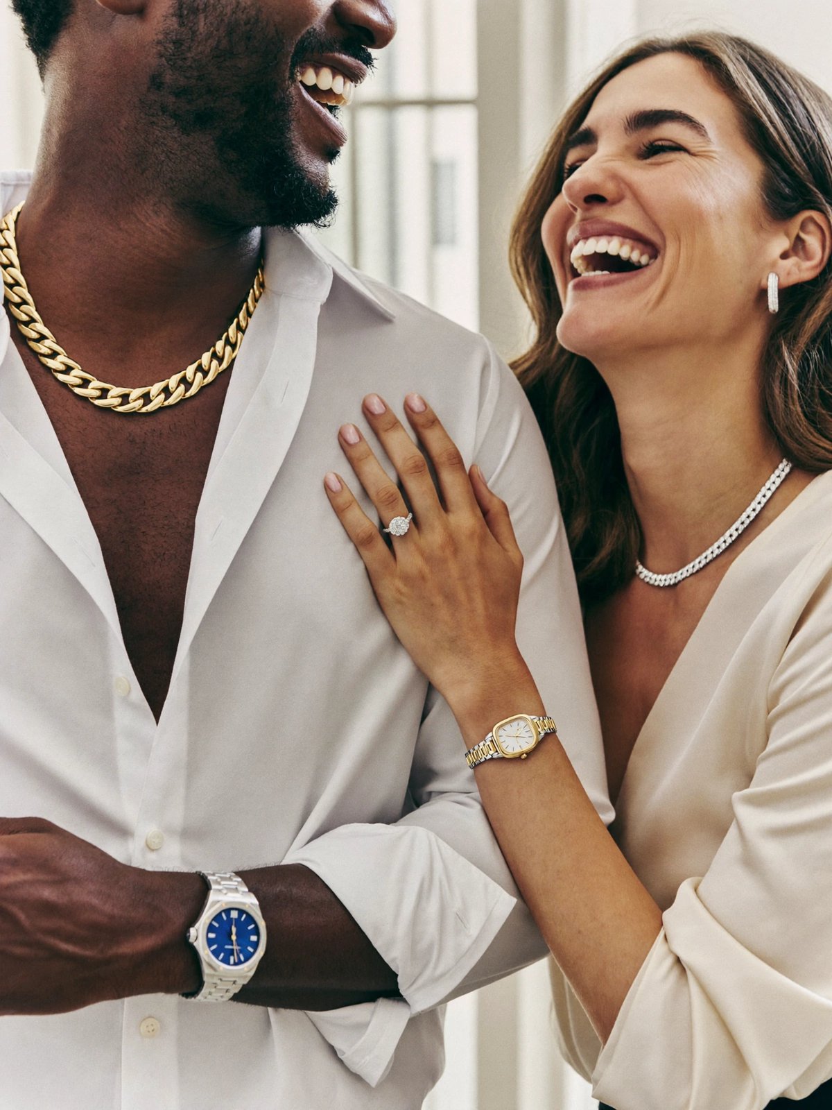 Couple wearing a gold chain, diamond ring and luxury watches
